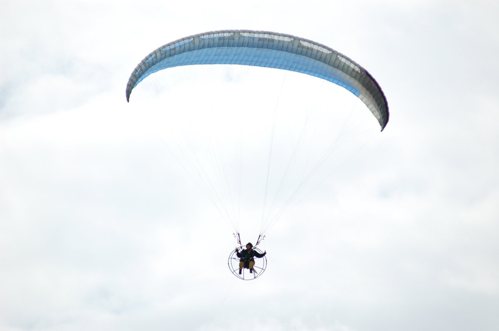 a man is parachute surfing in the air