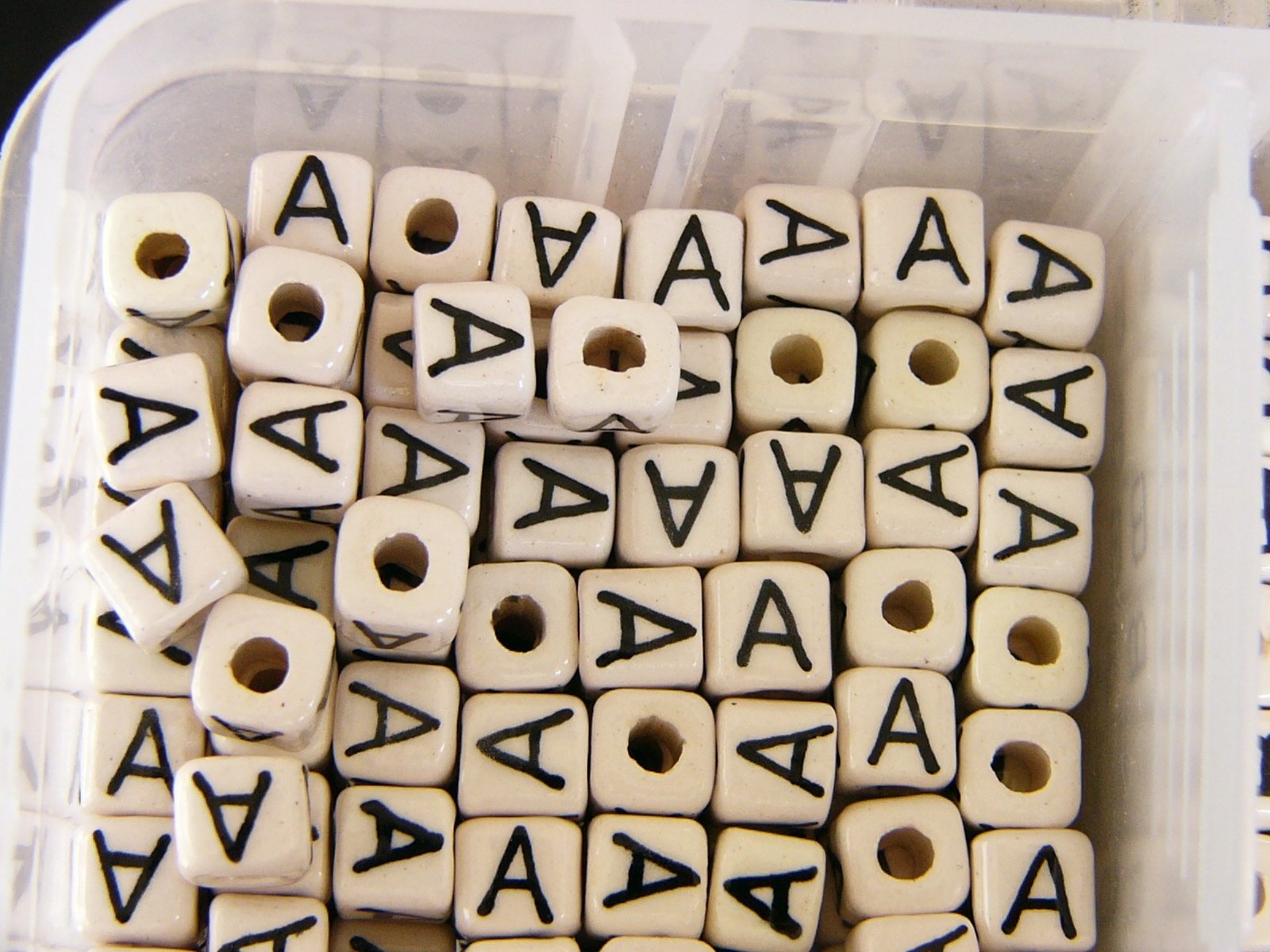 several different types of dice are sitting in a plastic box