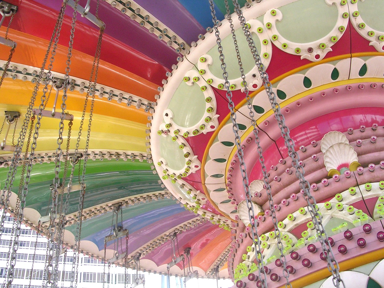 there are several rainbow colored umbrellas hanging