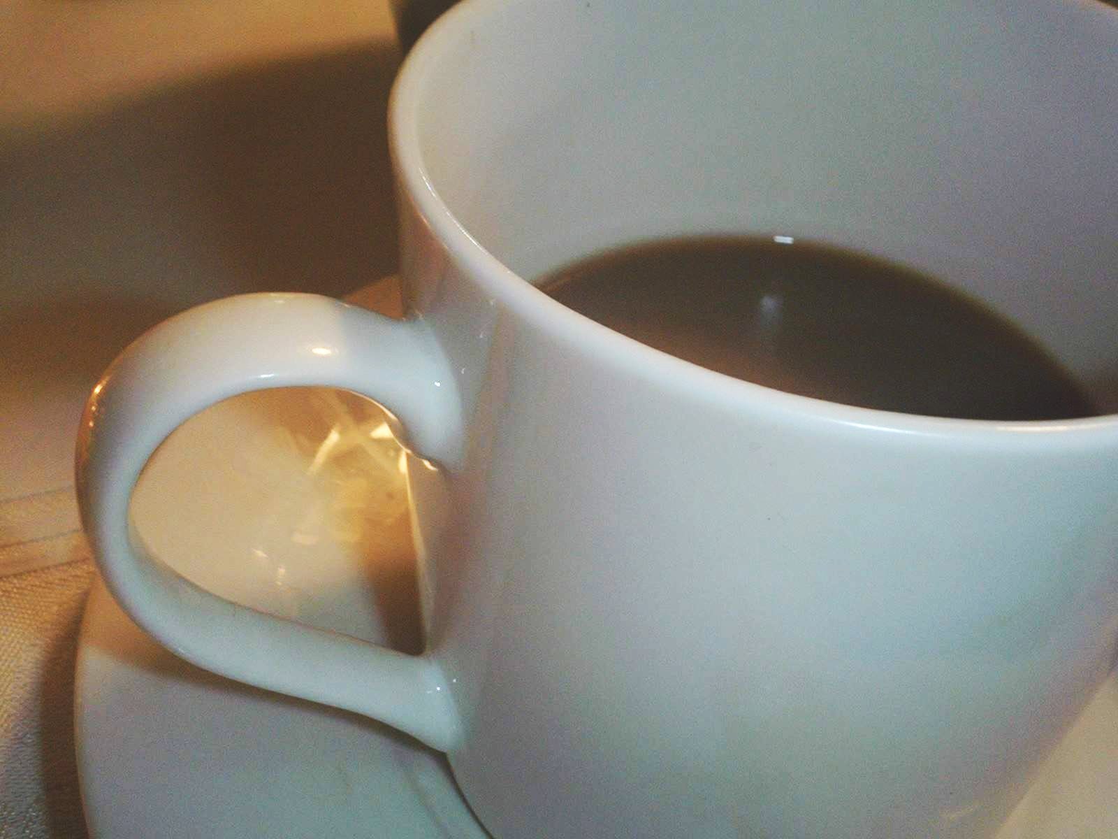 a close up of a cup of coffee on a saucer