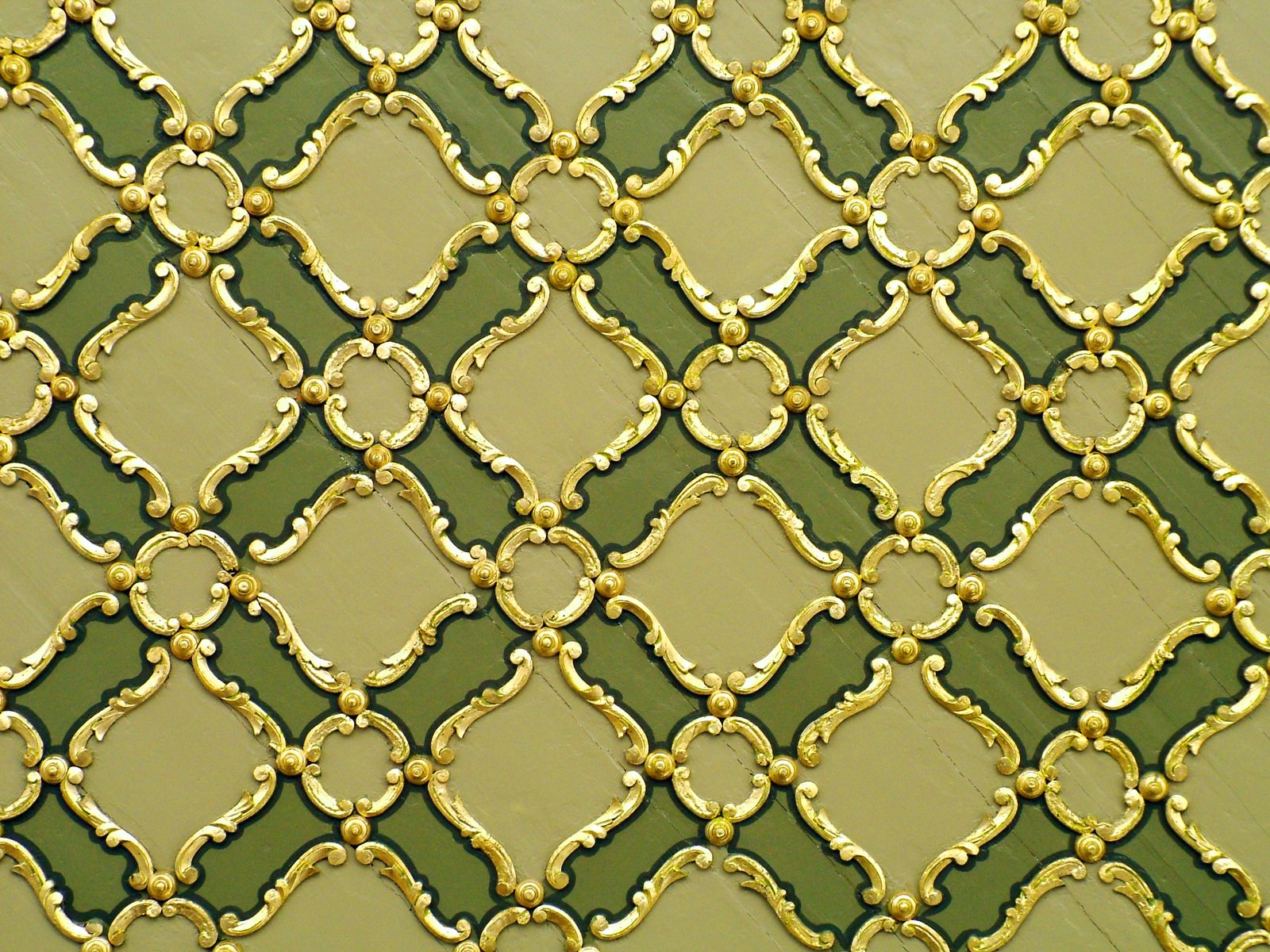 a green and yellow pattern with a gold design