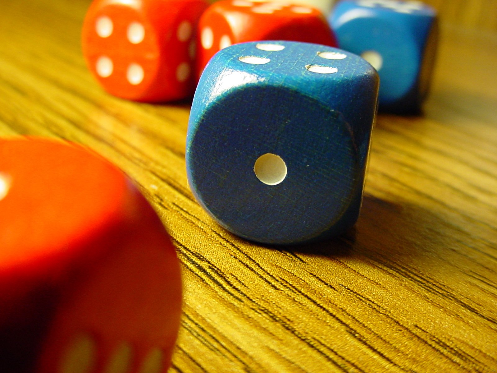 several wooden toy dices on a wooden table