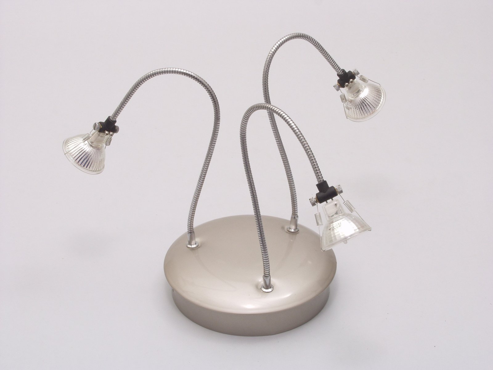 a metal light with three lights, with one cord attached