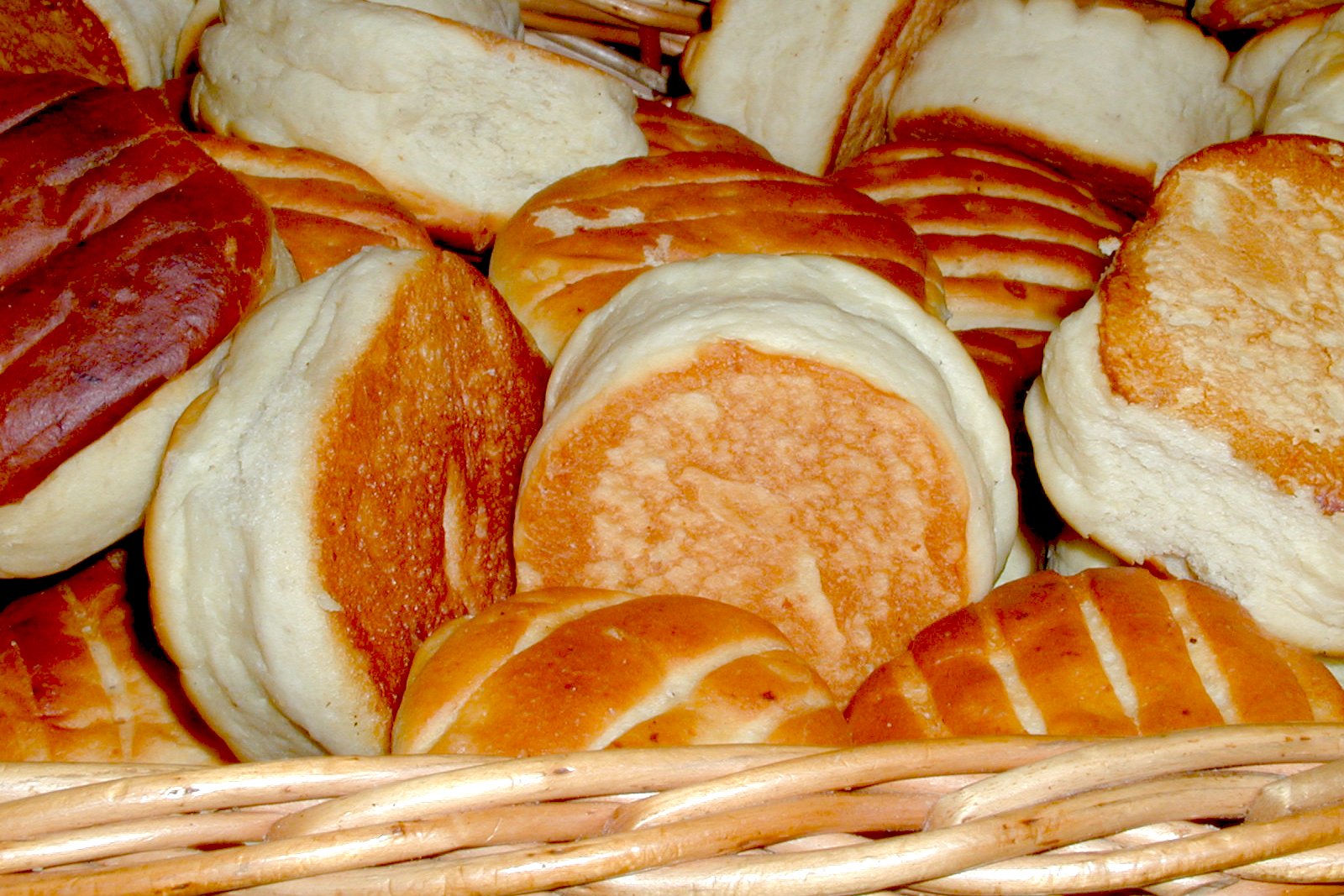 a wicker basket filled with lots of bread