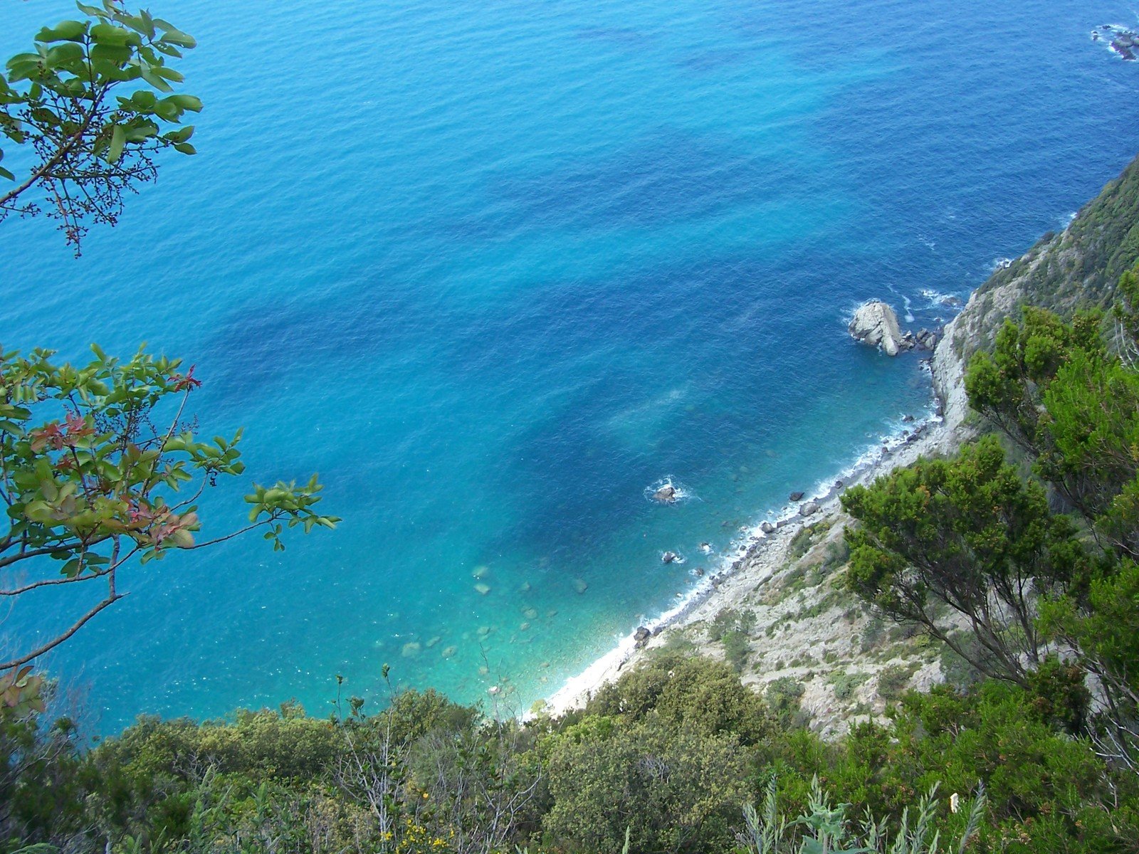 the beach and ocean from the cliffs of an island