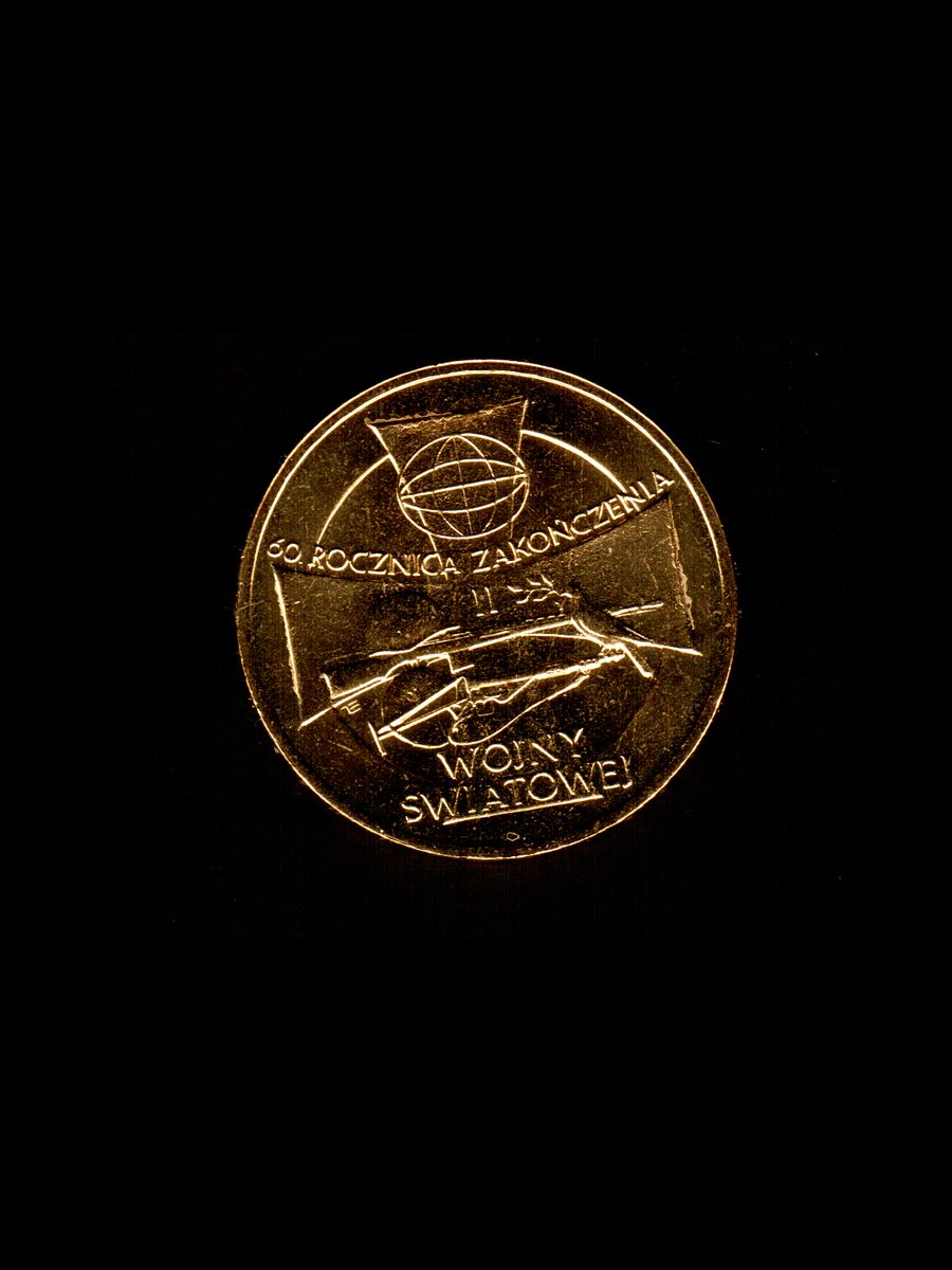 a small gold medal with the image of an aircraft