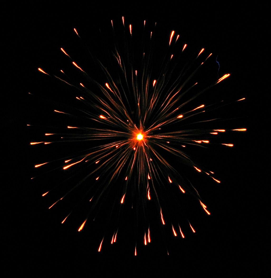 a red firework is shown in the night sky