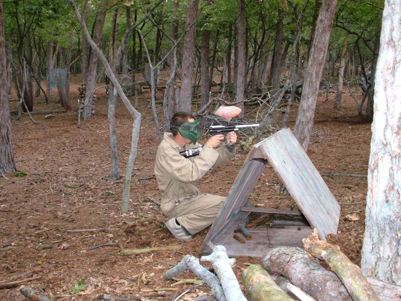 a man is aiming an object at soing