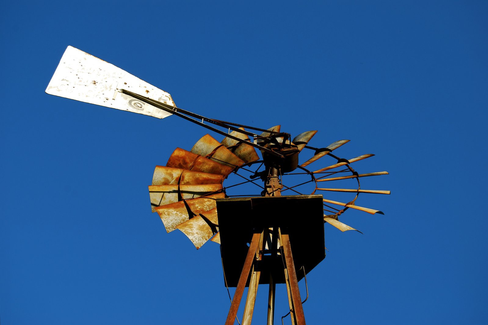 a wind powered windmill on a clear day