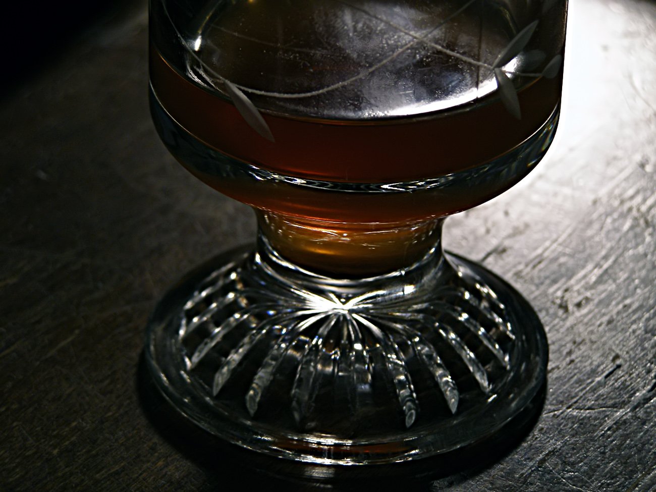 a dark colored glass sitting on top of a table