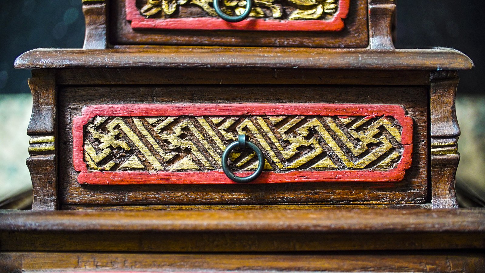 a close up of two drawers, one with a ring