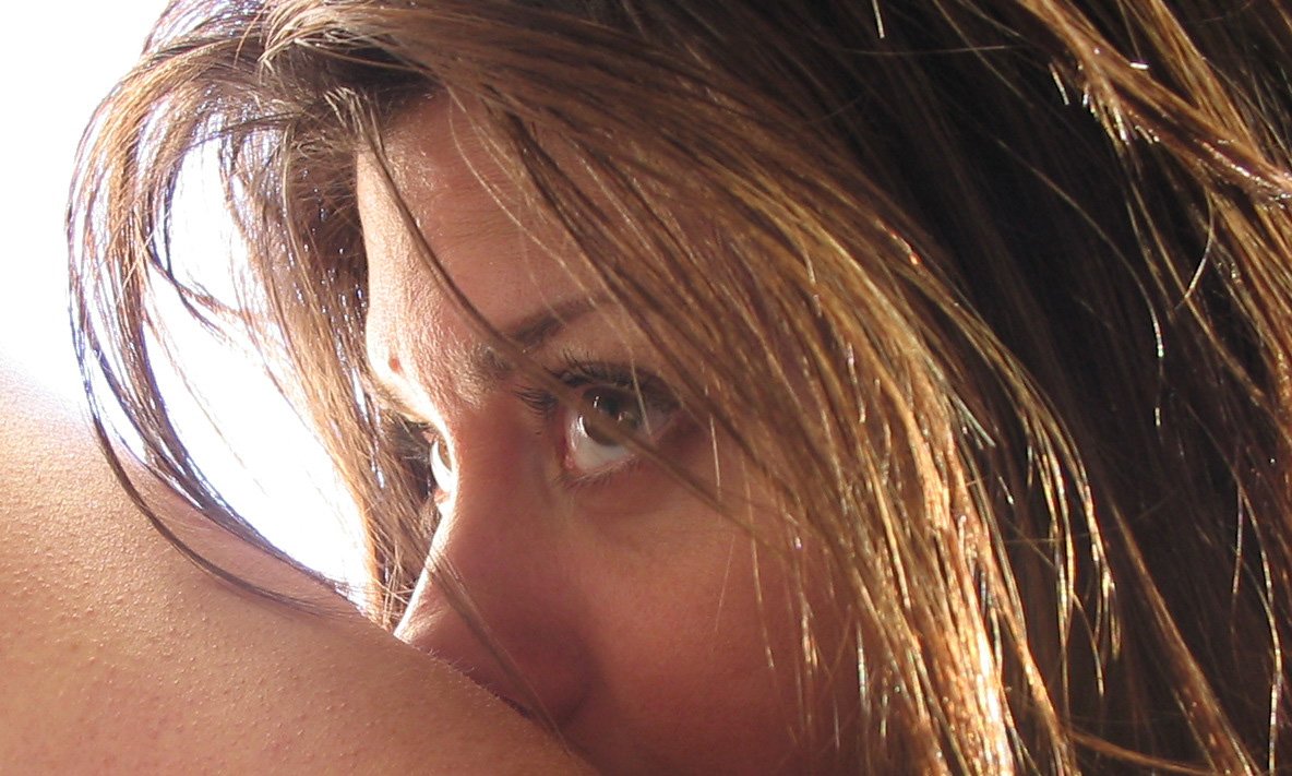 a woman's head with very long, wet hair on top of her chest