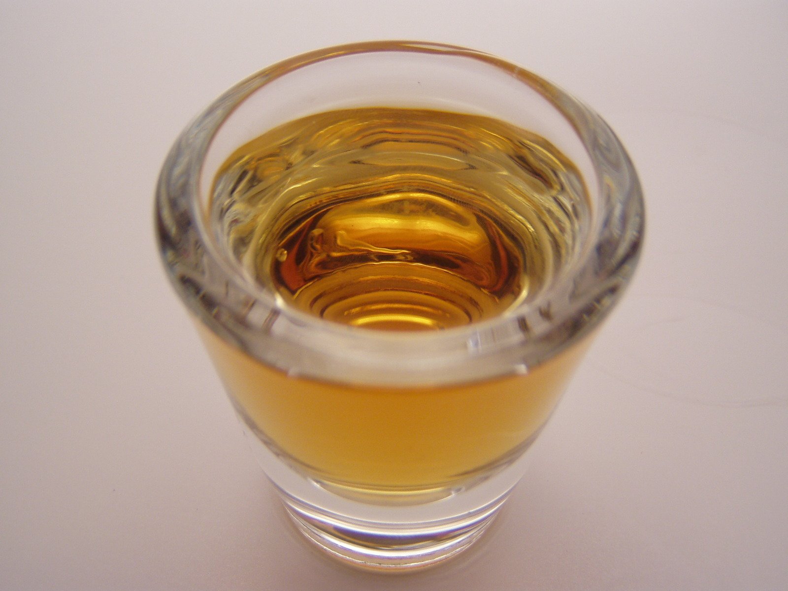 an empty glass with soing yellow in it