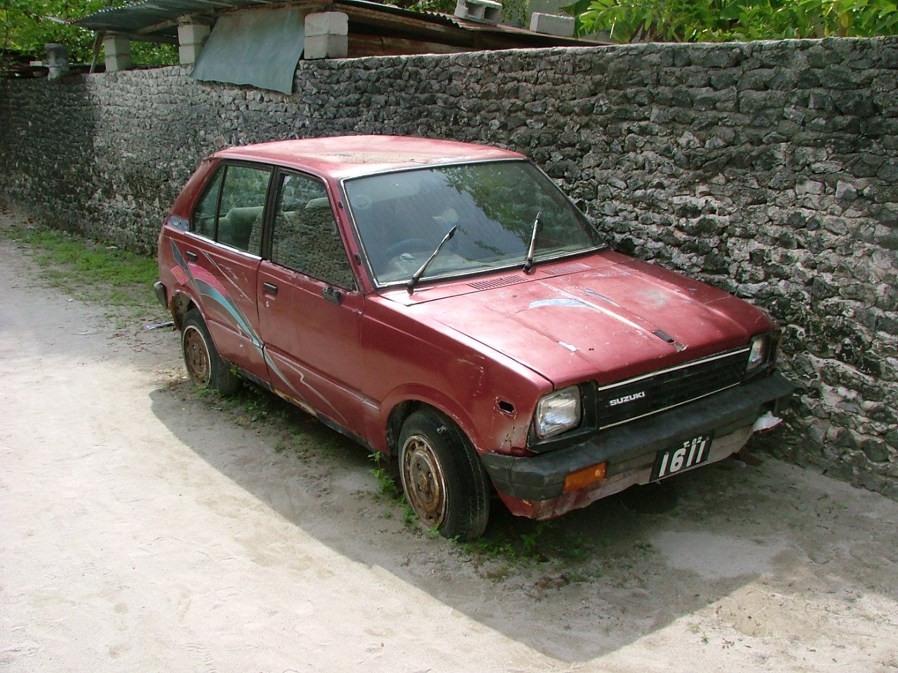 a car parked next to an old brick wall