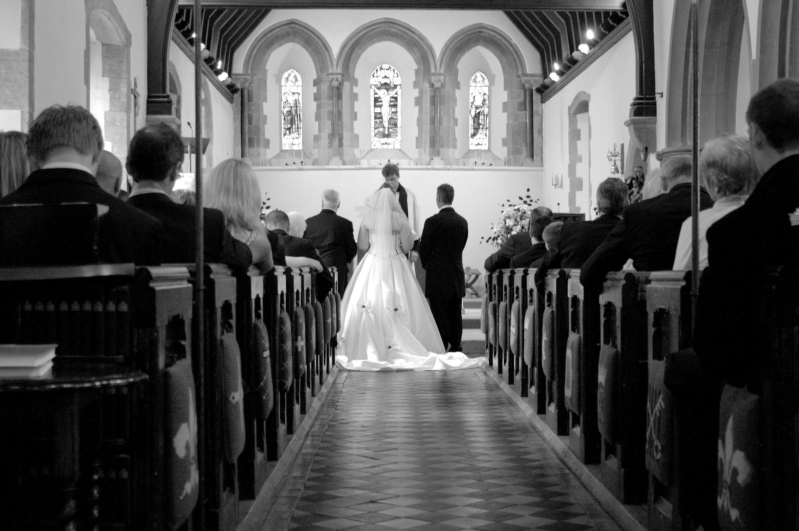 a bride and groom during their wedding ceremony at a church