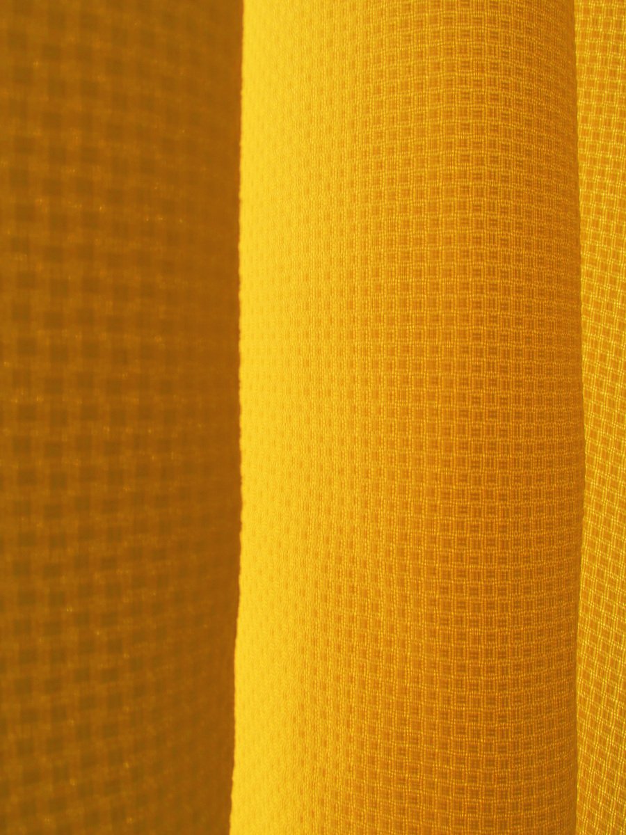 closeup s of a window screen in yellow