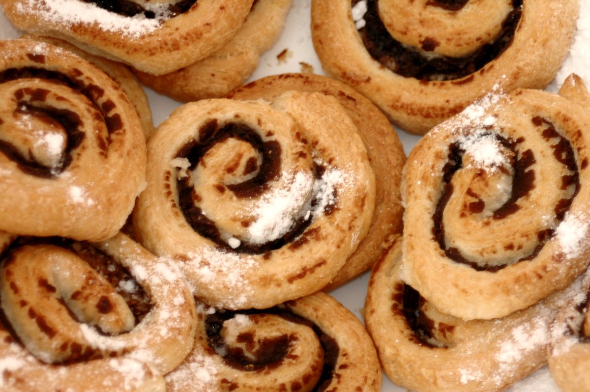 a pile of cinnamon roll wrapped in powdered sugar