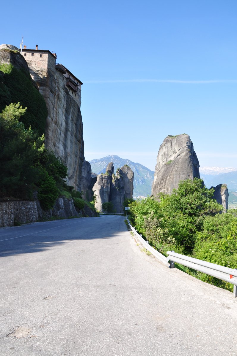 a road near a tall rock cliff