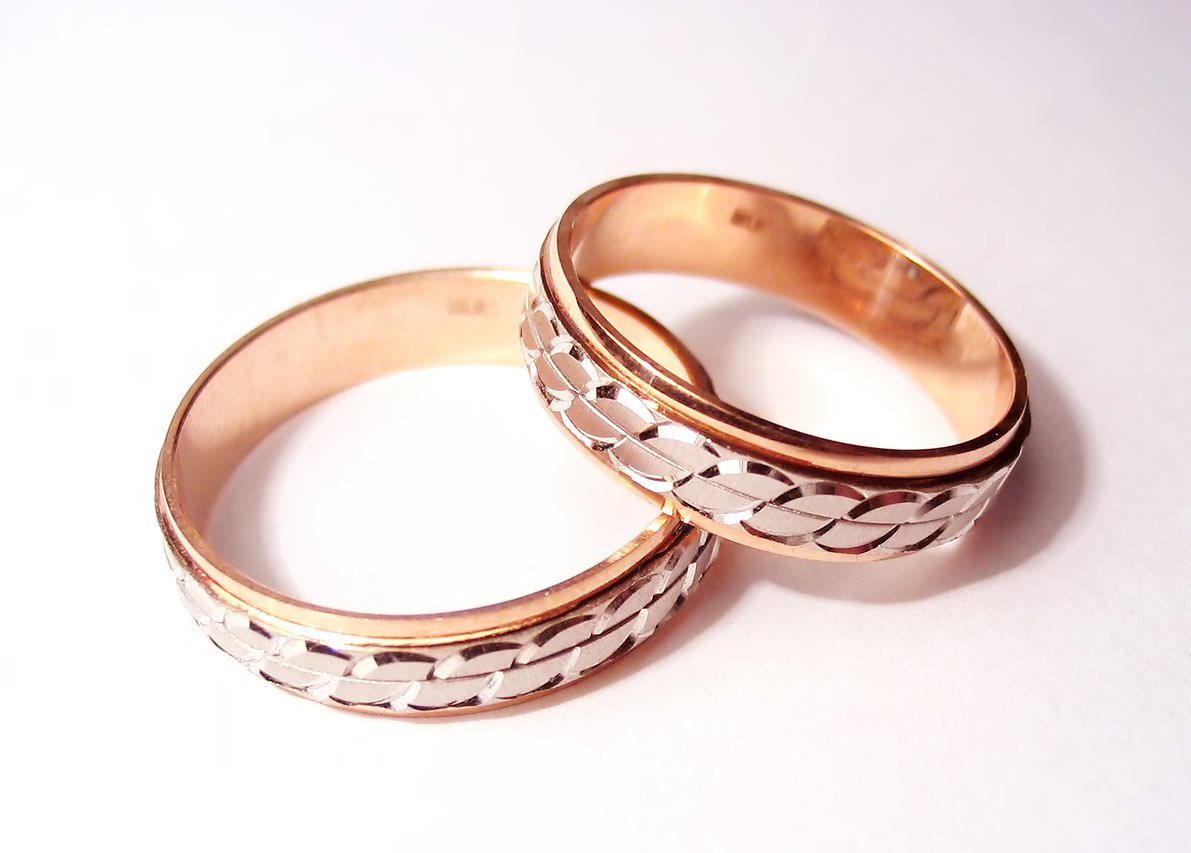 two wedding bands are shown on the white surface