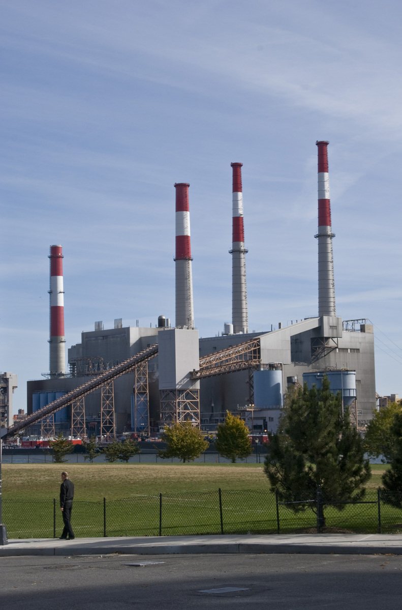 a large factory building sitting on top of a grass field