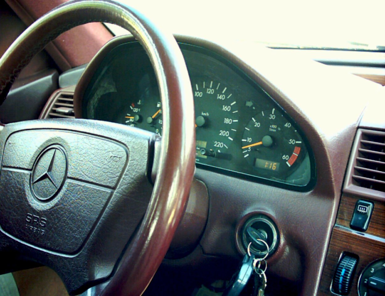 a dashboard with several clocks and car keys in a vehicle