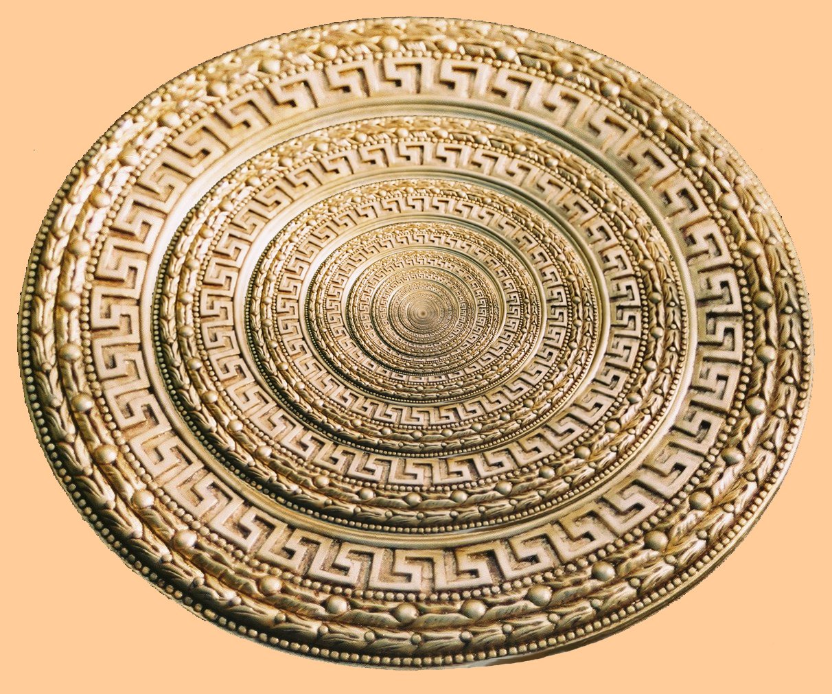 gold colored plate with a pattern in the middle