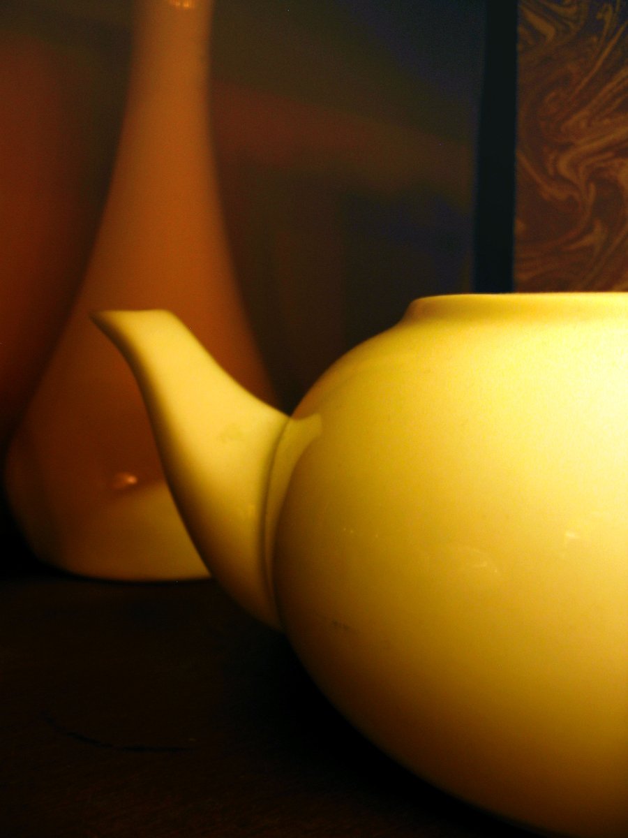 a yellow teapot on a wooden table