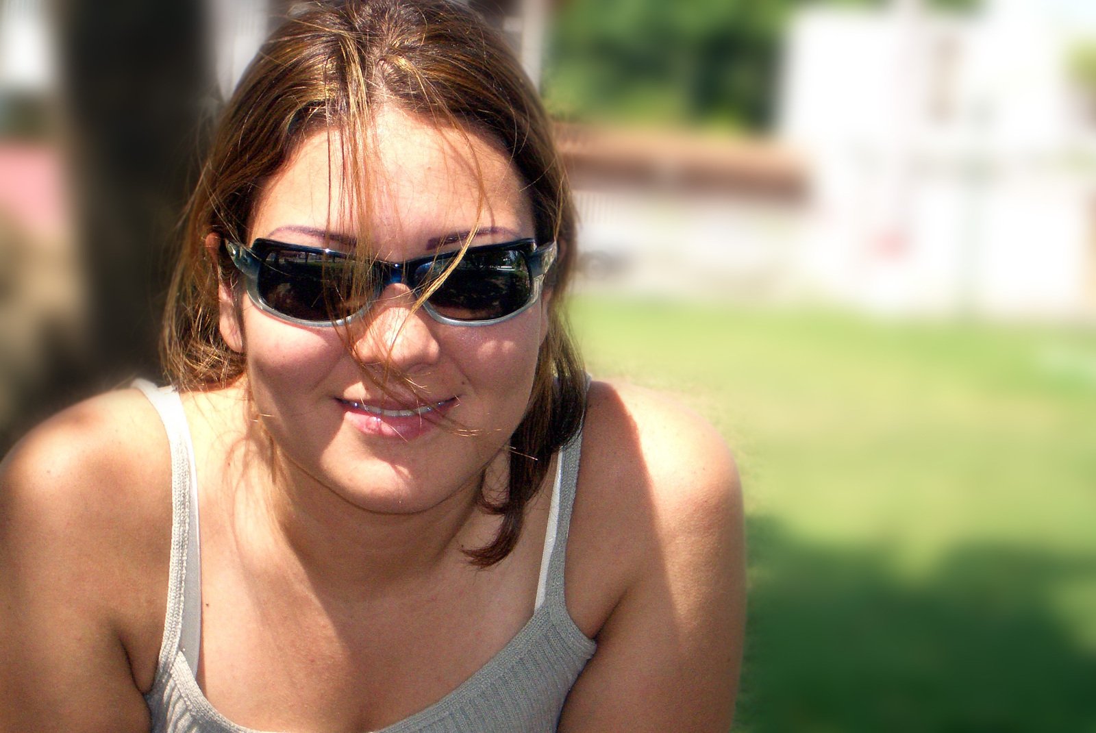 a beautiful woman in sunglasses making a funny face