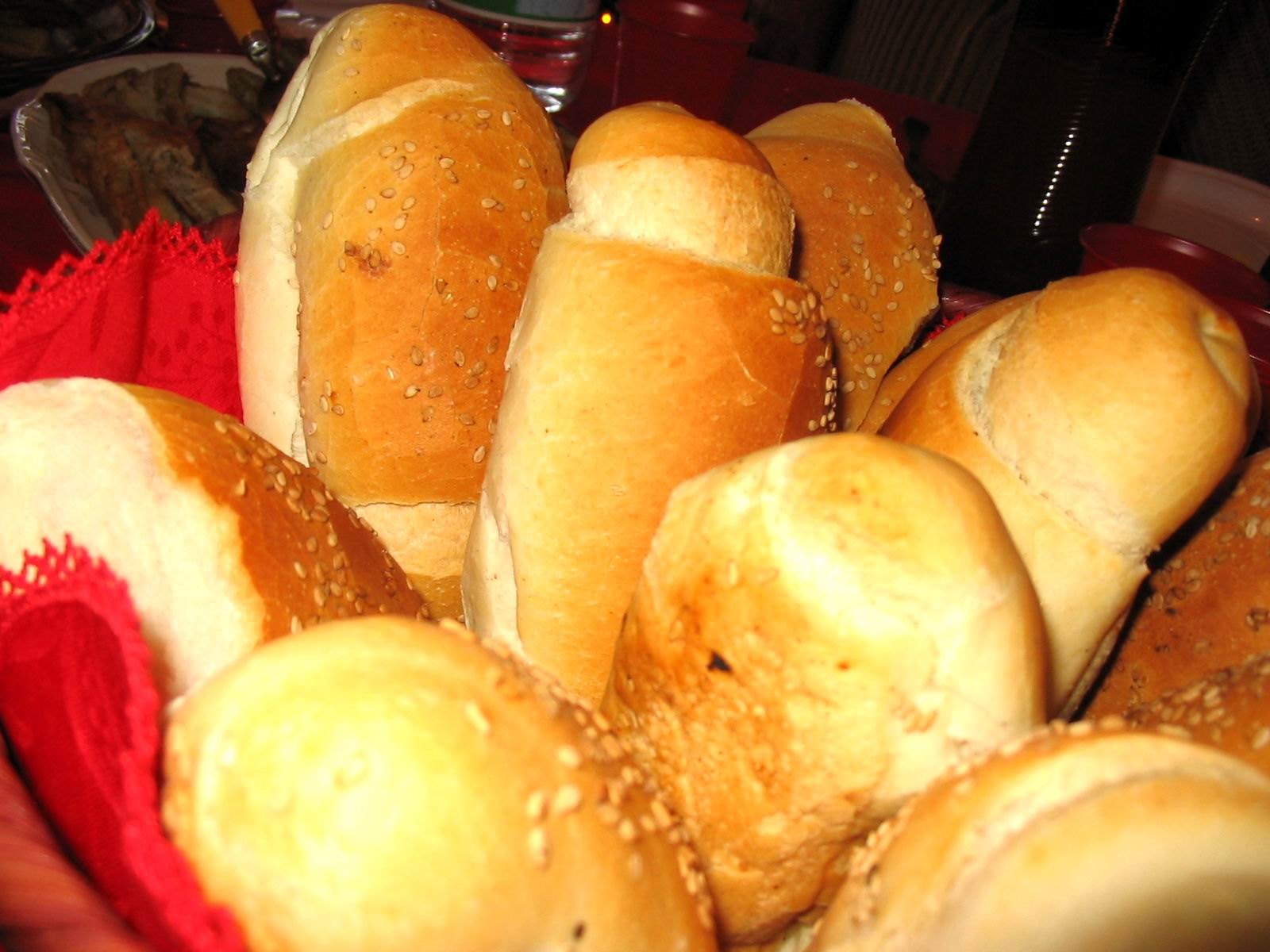 bread rolls piled up in a red basket