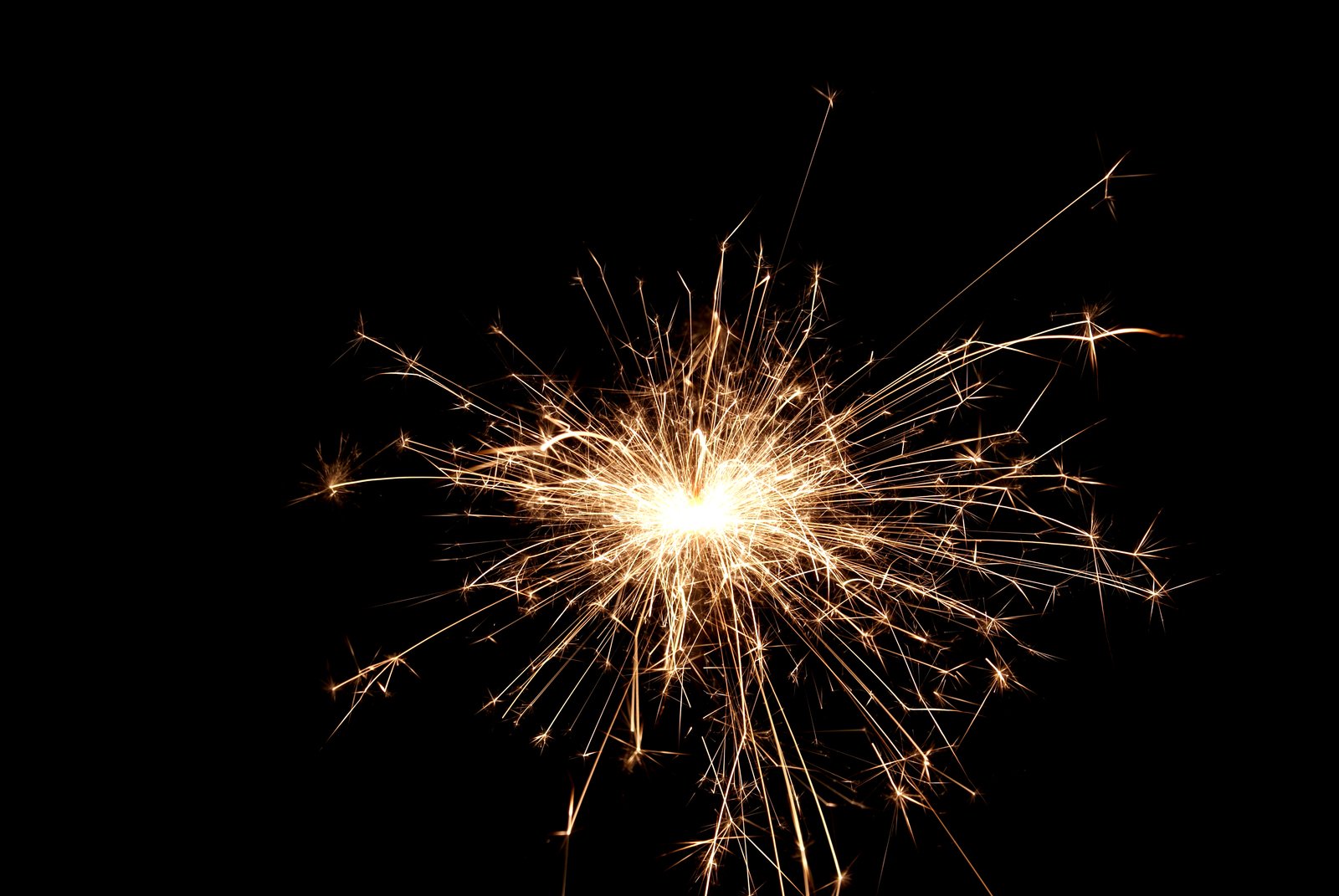 an image of fireworks and sparks in the dark