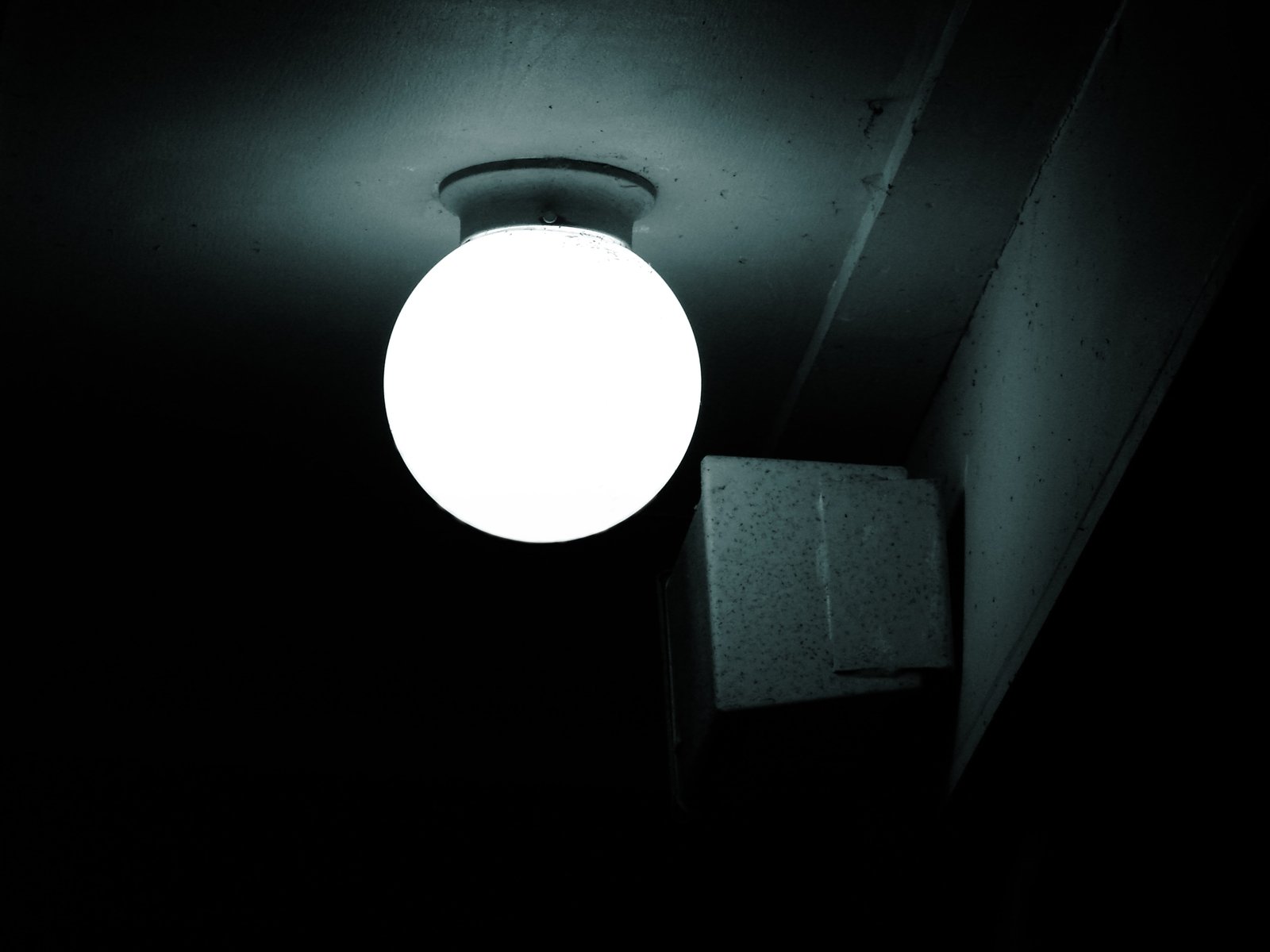 a black - and - white po shows an illuminated orb in the dark