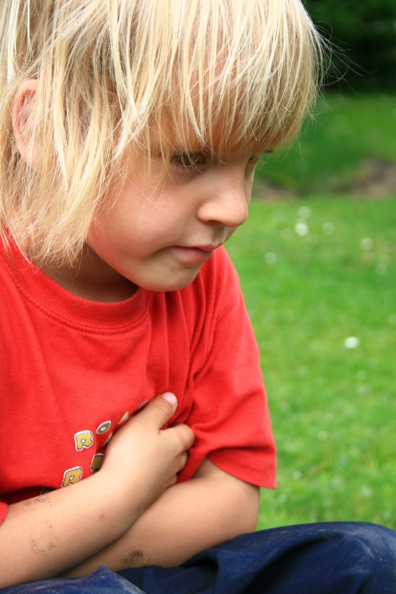 a child with blonde hair in a red shirt