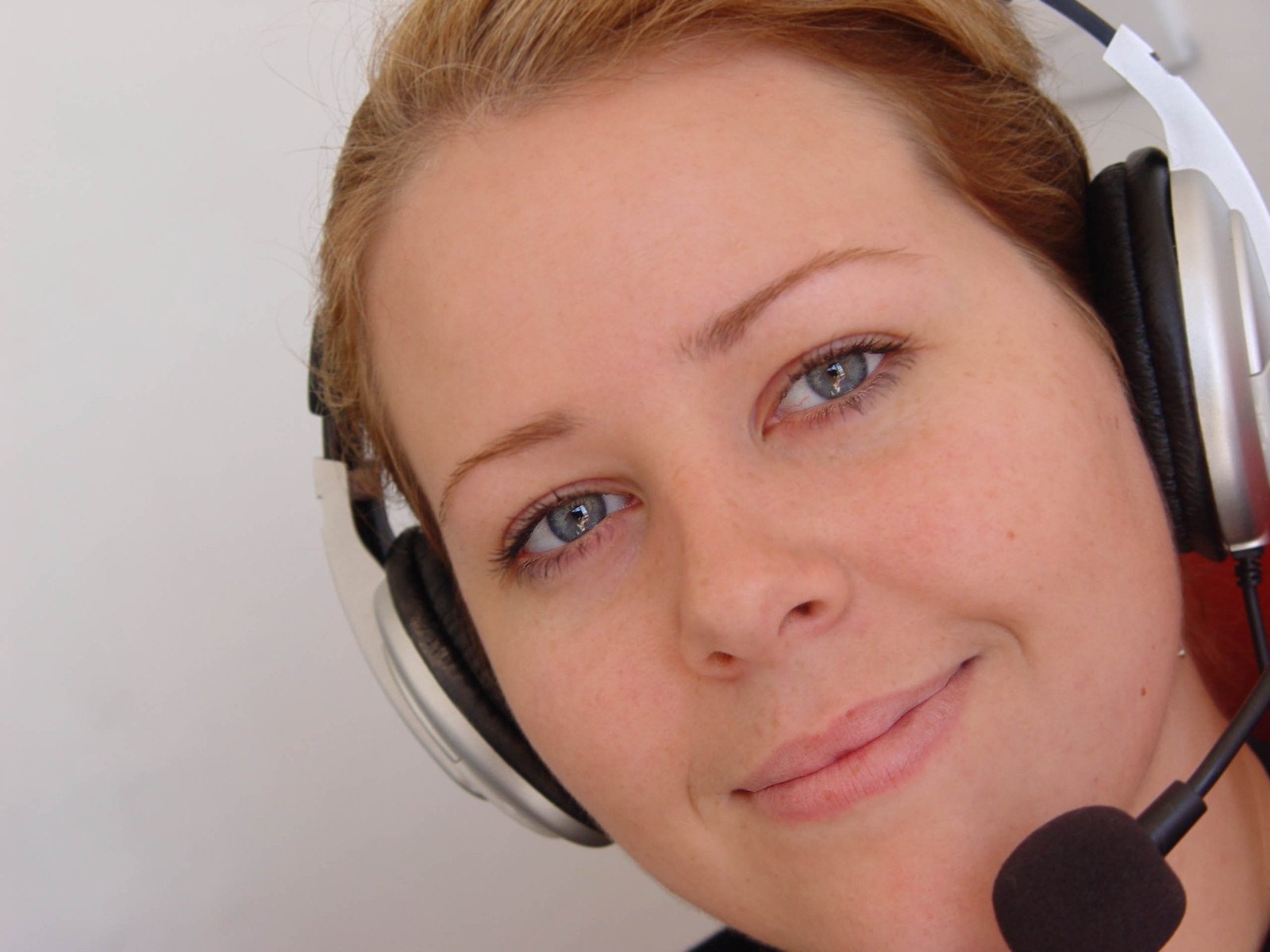 a woman with headphones looking at the camera