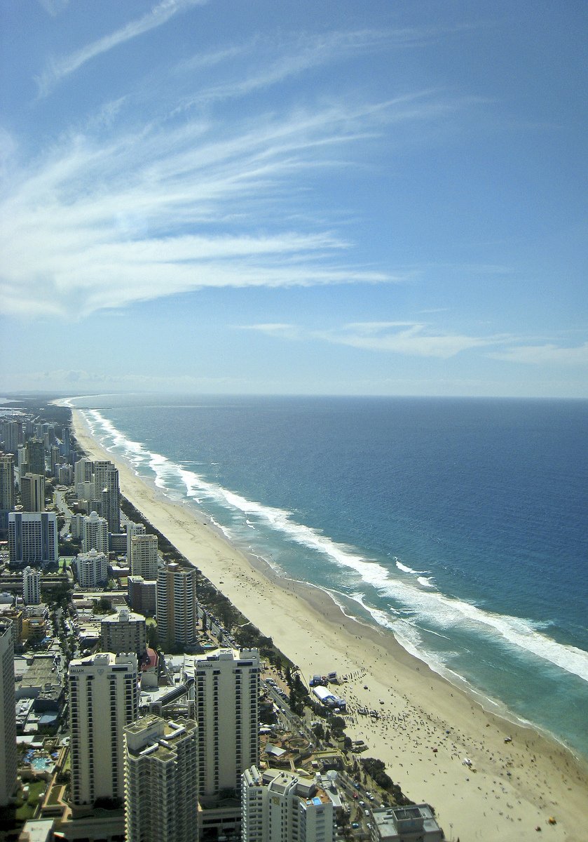 an aerial view of the beach, city, and ocean