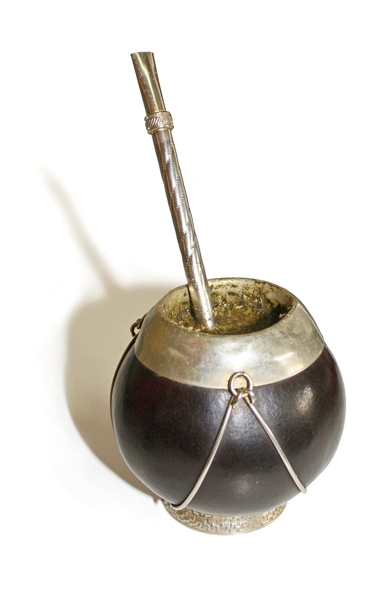 a metal ball with a silver handle and a straw