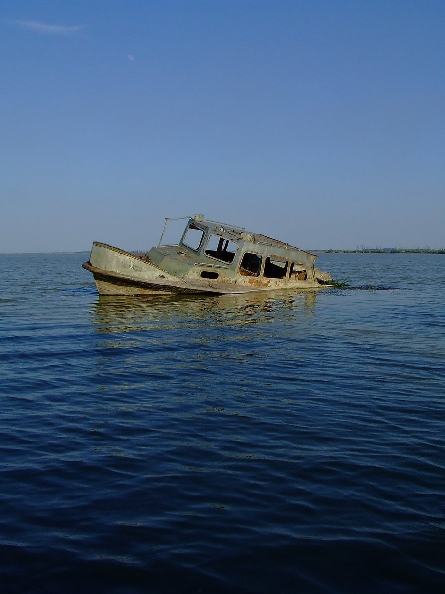 a lone old boat floating in the ocean