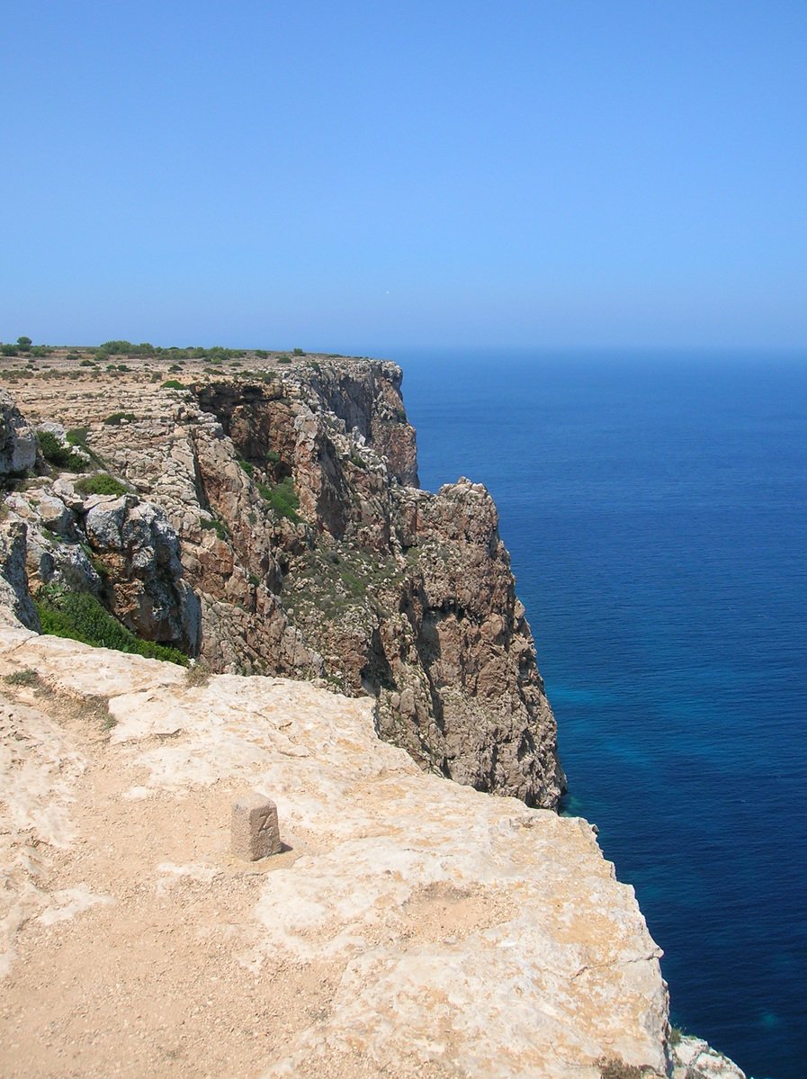 two rock formations on a cliff above an ocean