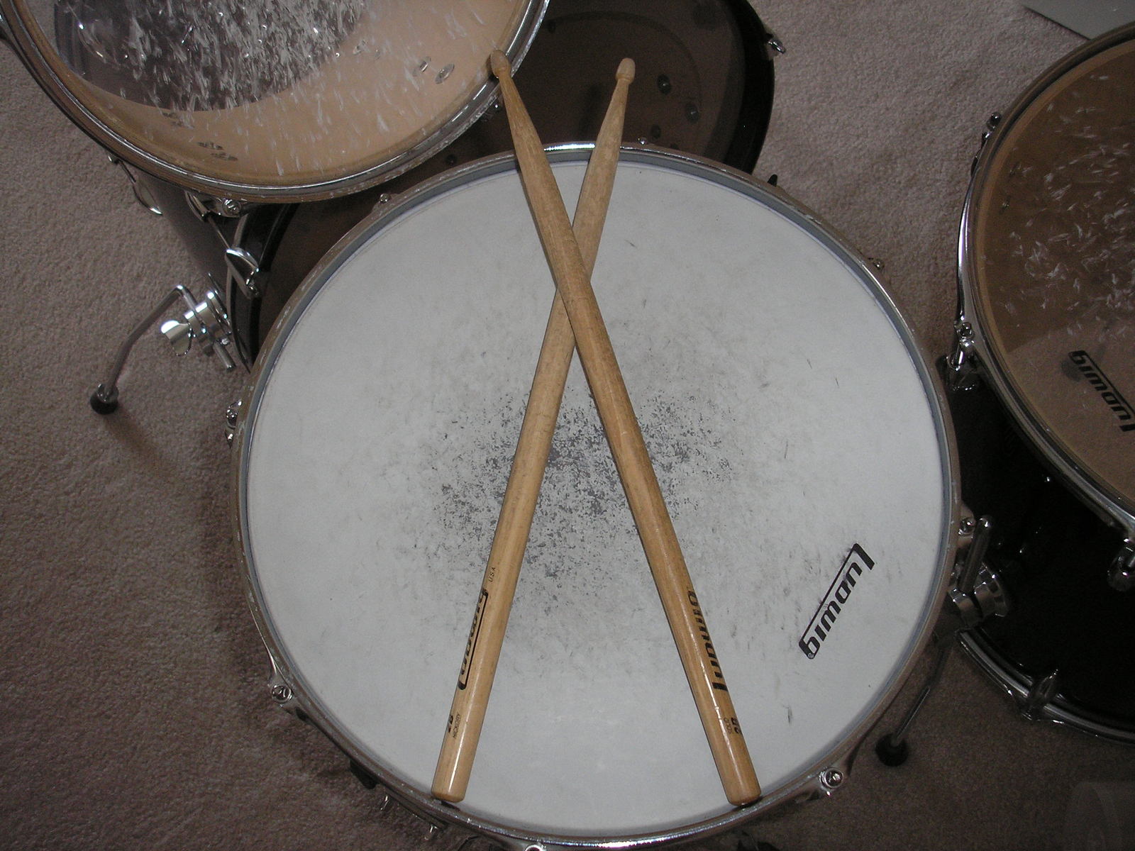 drums with two sticks on top, in the middle of three drums