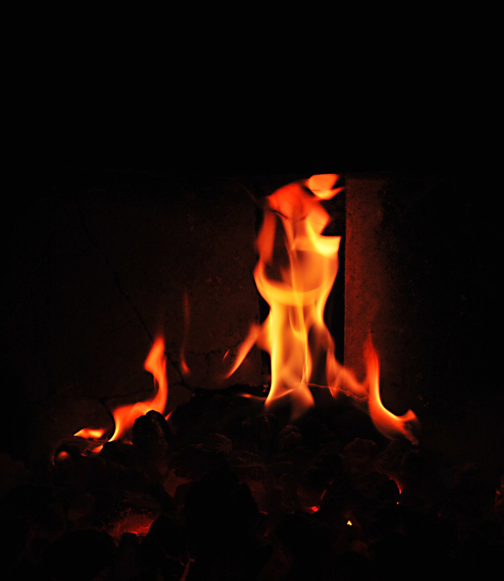 flames glow brightly in the dark from fire