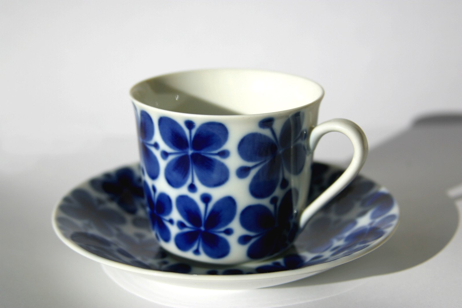 the cup is blue and white with a flower design