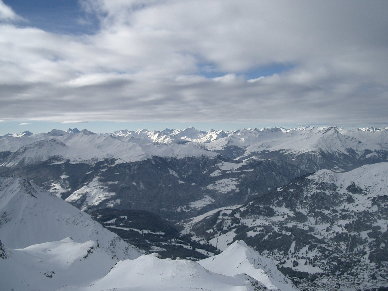 a view of some snowy mountain tops from a plane