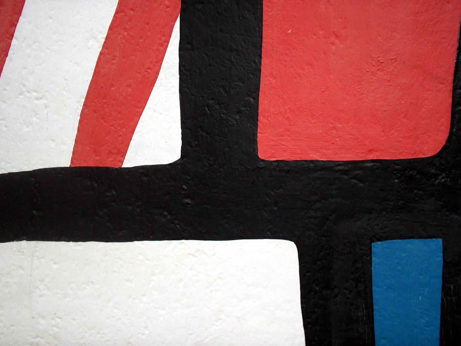 the abstract painting shows a black, red and white design