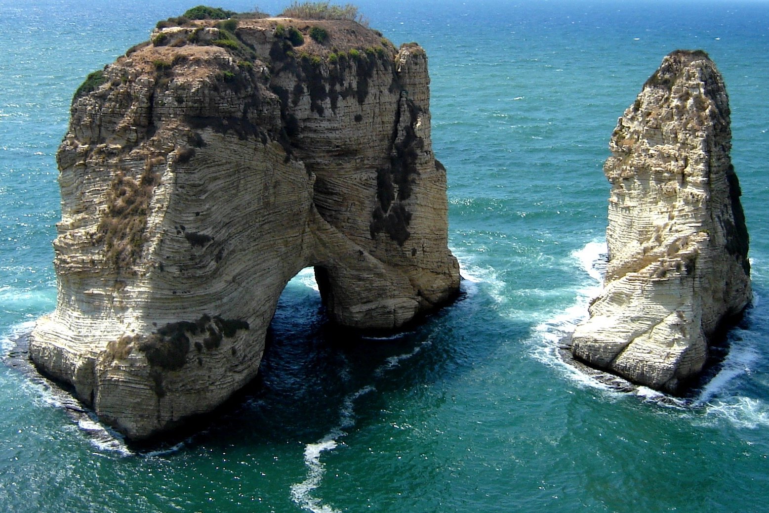 there is a rock formation in the middle of the ocean