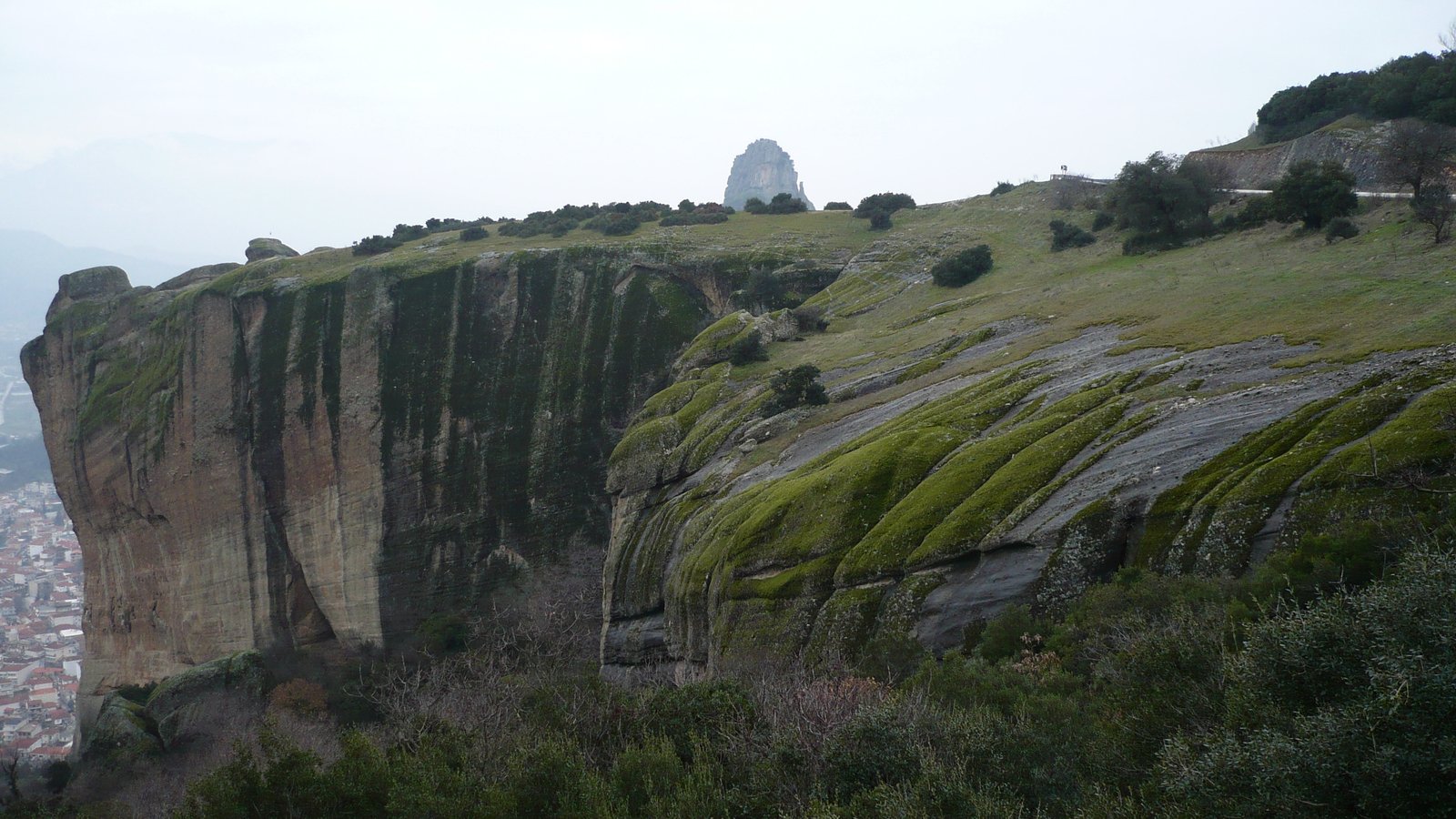 a large cliff in a very scenic area that looks very small