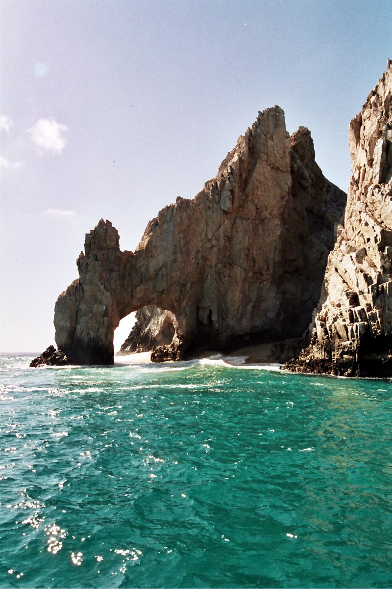 a large rock formation in the middle of the ocean