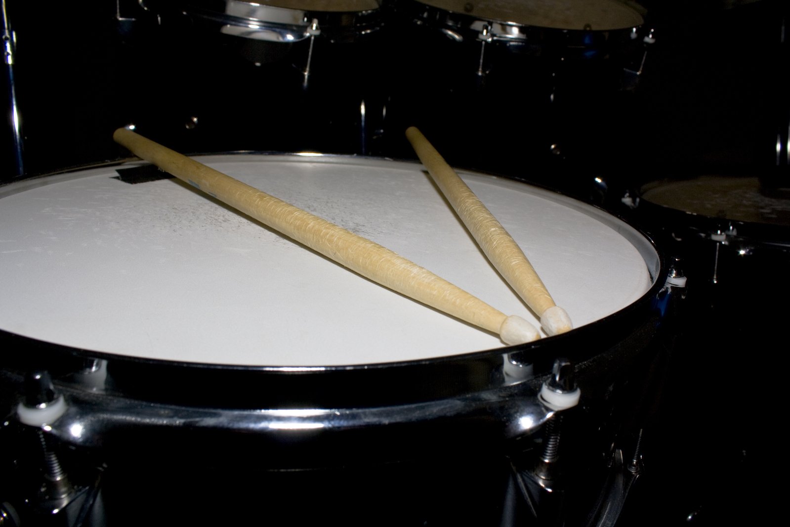 two sticks sticking out from inside a drum head