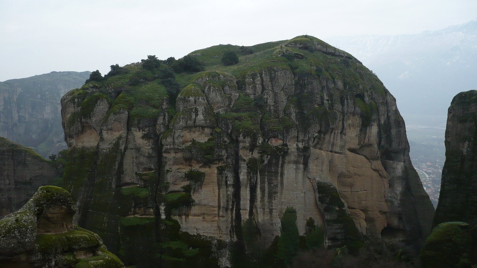 the peak of a mountain with grass growing on it