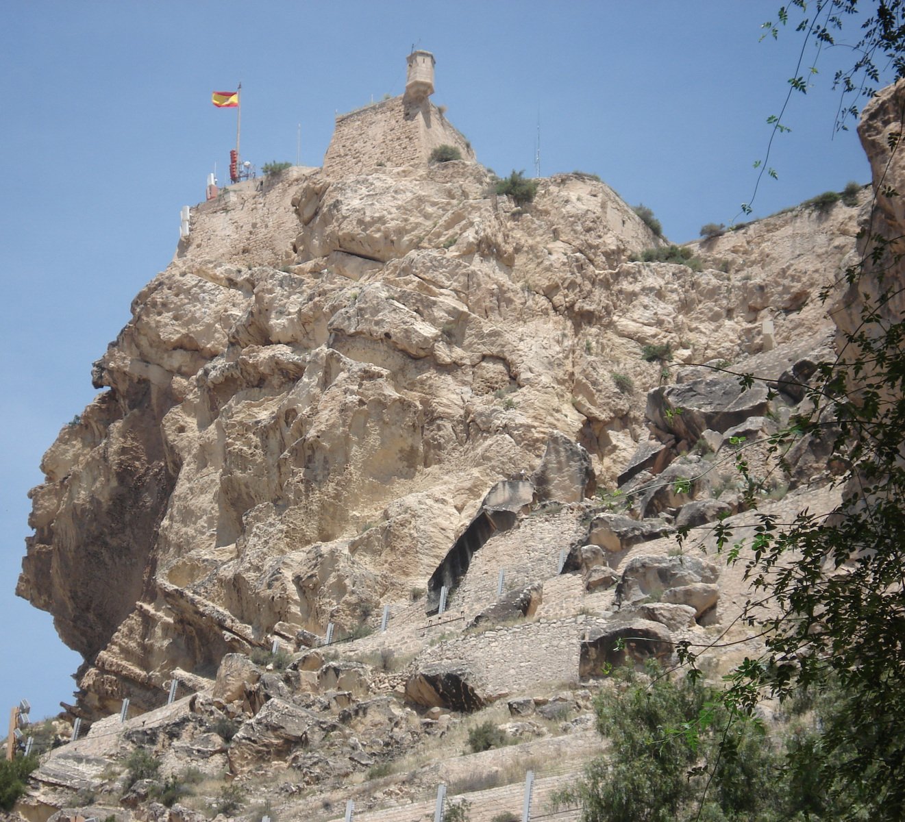 a big rock formation with a flag on top