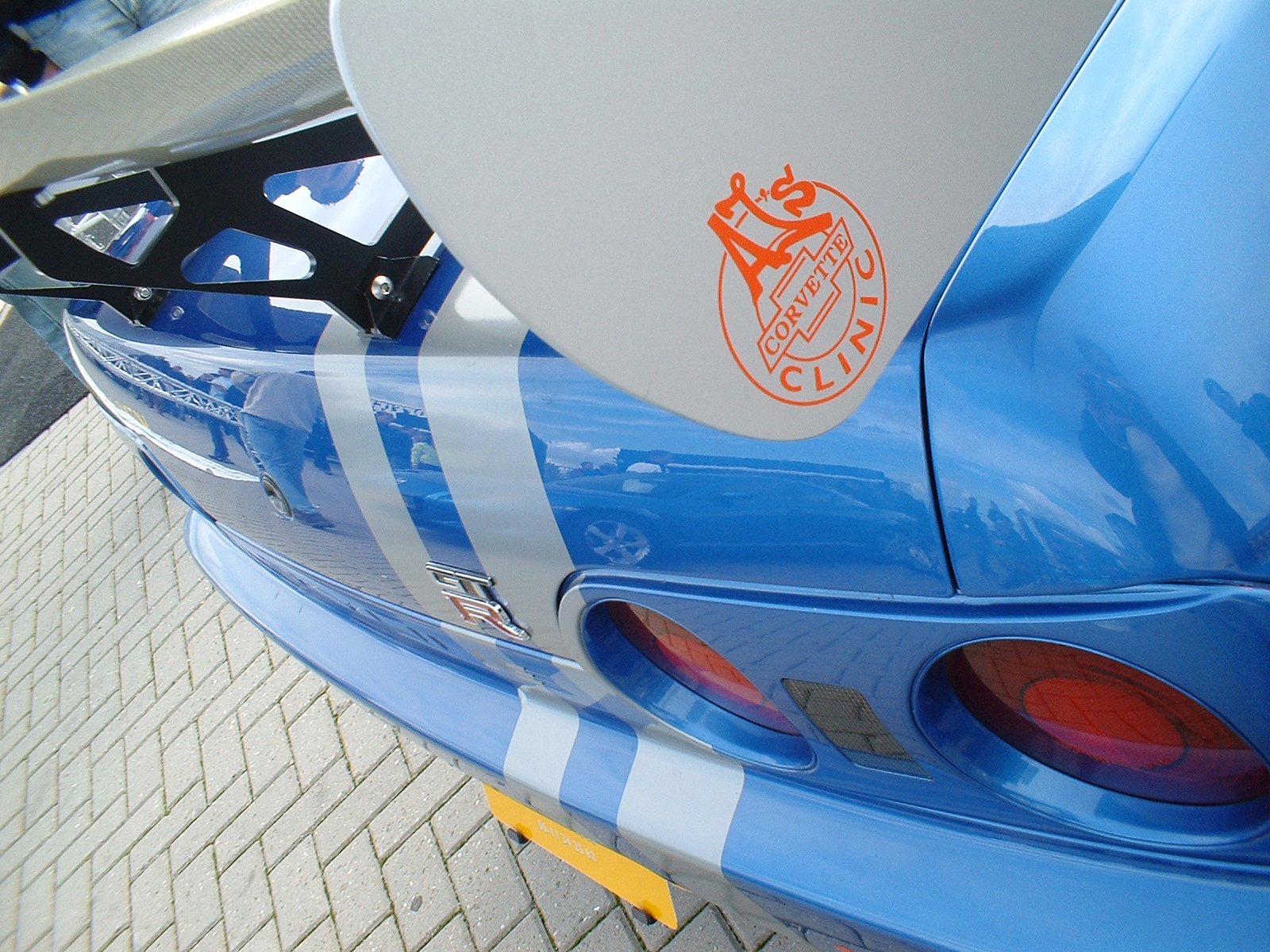 the tail end of a sports car with the emblem of manchester city on it