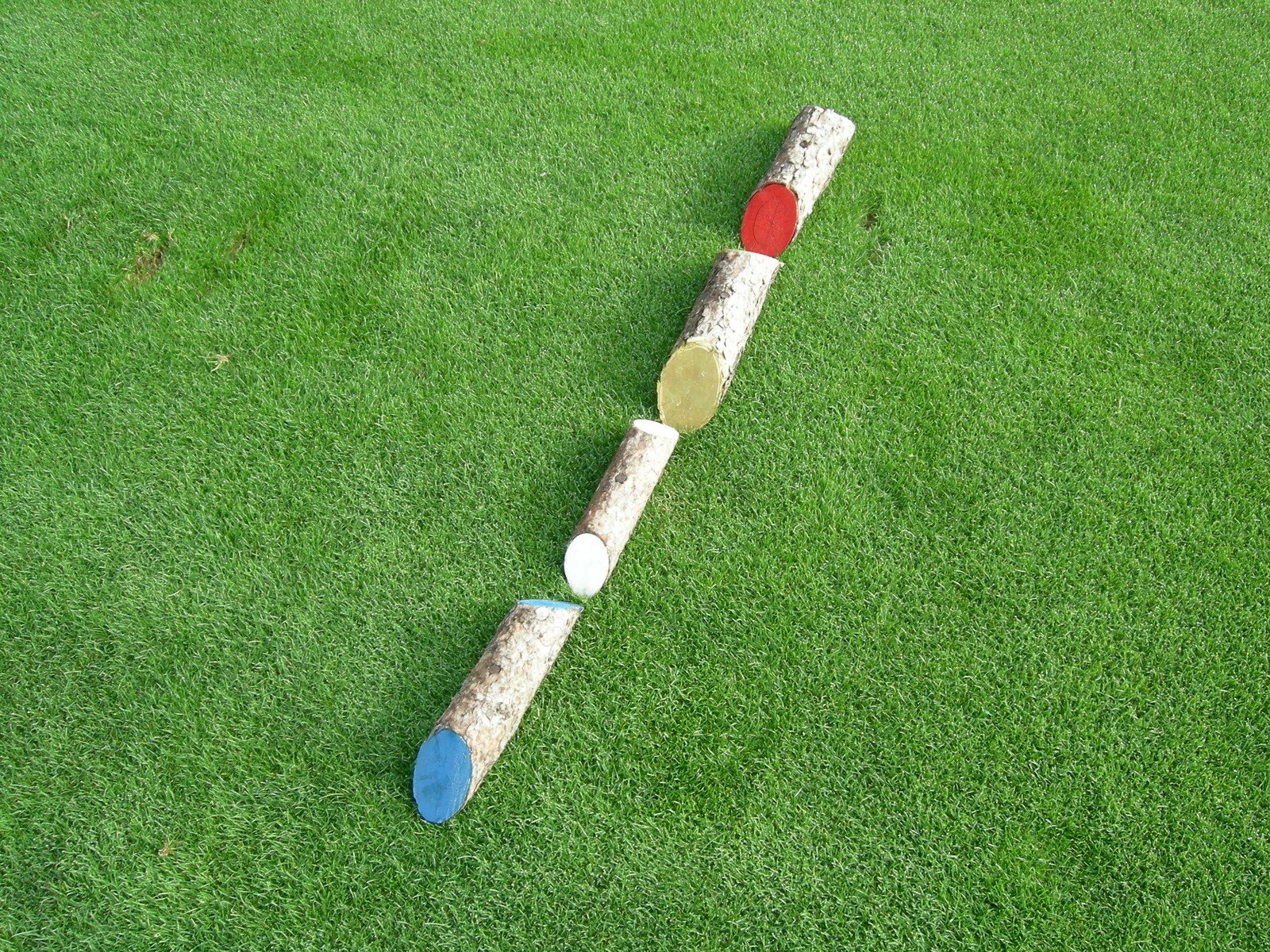 some very long baseball bat on some green grass